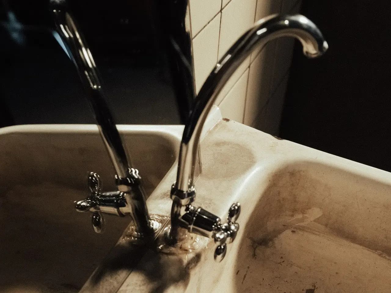 Example before: stained old sink with a dated faucet